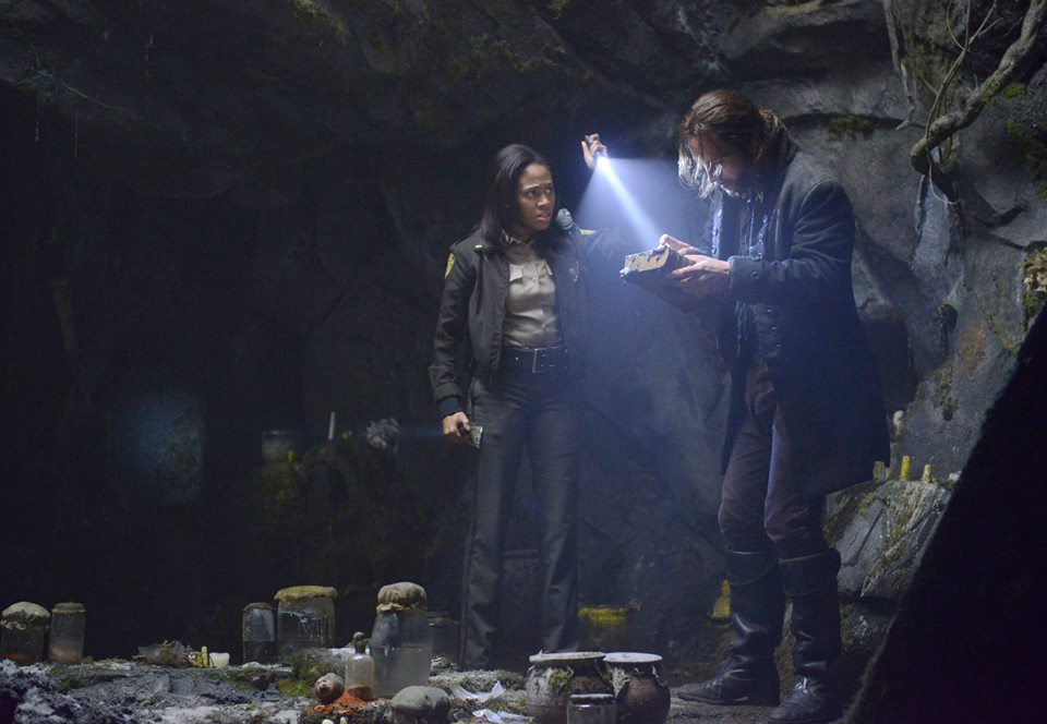 Ichabod and Abbie examine George Washington's bible in a cave on Sleepy Hollow