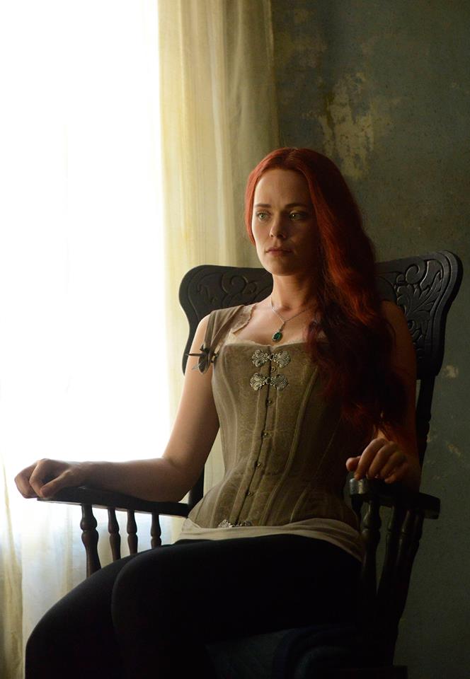 Katrina sits in a rocking chair on Sleepy Hollow