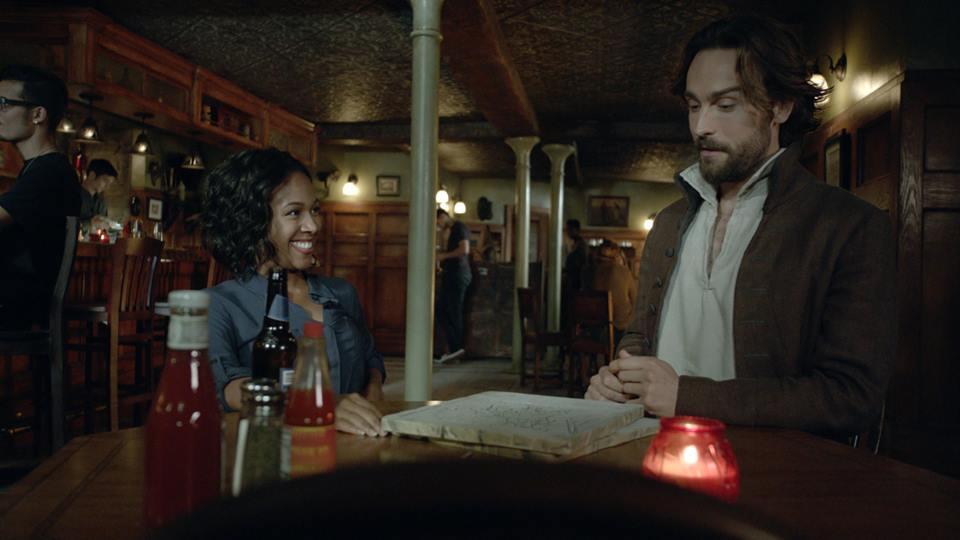 Ichabod (Tom Mison) and Abbie (Nicole Beharie) share drinks in the Sleepy Hollow, season premiere, "I, Witness."