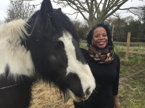 Elaine F. with a black and white horse.