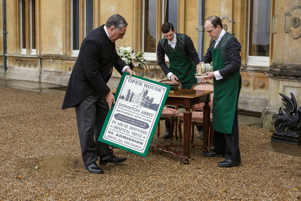 Mr. Carson and other servants put up an open house sign at Downton Abbey